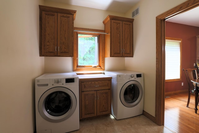 21601 Timber Hills Trl, Nisswa, MN 56468 - laundry area with cabinet space and washer and clothes dryer