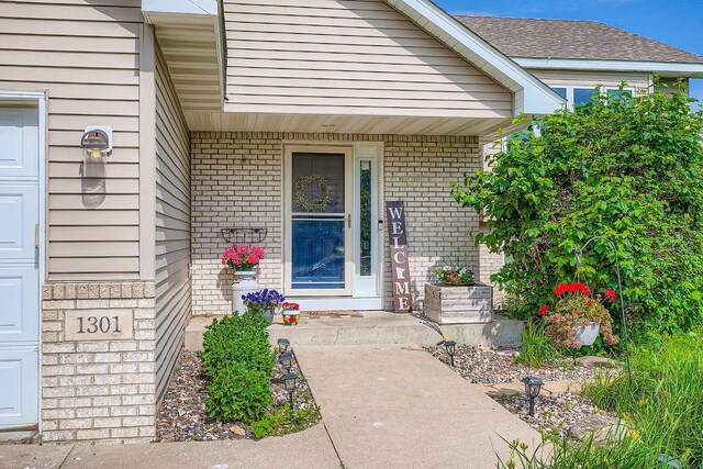 1301 English Ave NW, New Prague, MN 56071 - view of exterior entry with brick siding and covered porch