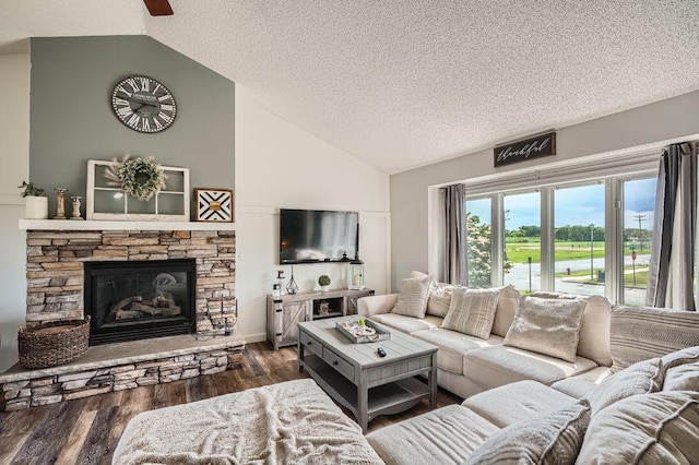 1301 English Ave NW, New Prague, MN 56071 - living area featuring a textured ceiling, wood finished floors, a fireplace, and high vaulted ceiling