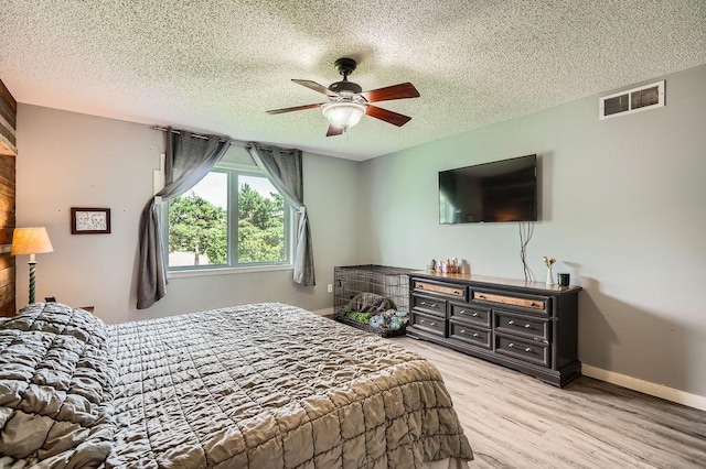 1301 English Ave NW, New Prague, MN 56071 - bedroom featuring a textured ceiling, light wood finished floors, and ceiling fan