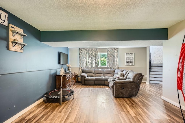 1301 English Ave NW, New Prague, MN 56071 - living room featuring wood finished floors, stairs, and a textured ceiling
