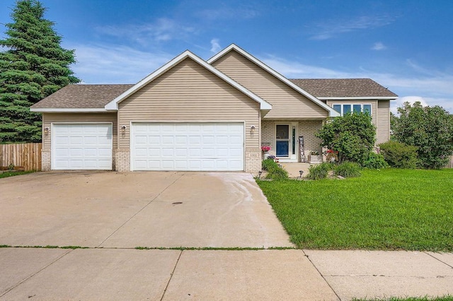 1301 English Ave NW, New Prague, MN 56071 - view of front of house with brick siding, a garage, concrete driveway, and a shingled roof