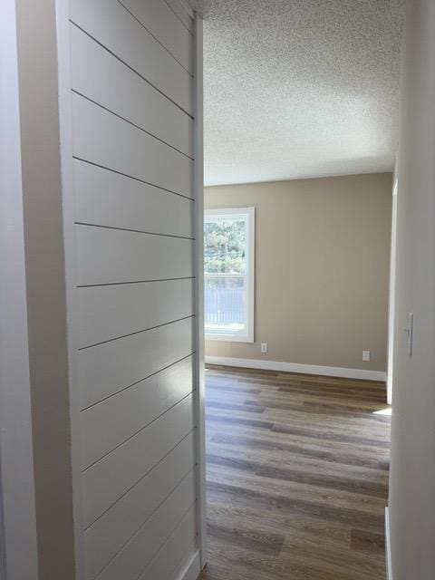 20 Erie St, Aurora, MN 55705 - hallway with a textured ceiling and wood finished floors