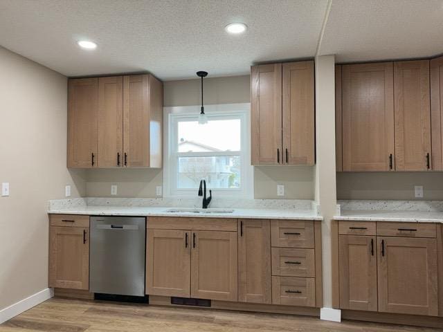 20 Erie St, Aurora, MN 55705 - kitchen featuring stainless steel dishwasher, light wood-style flooring, decorative light fixtures, recessed lighting, and a textured ceiling