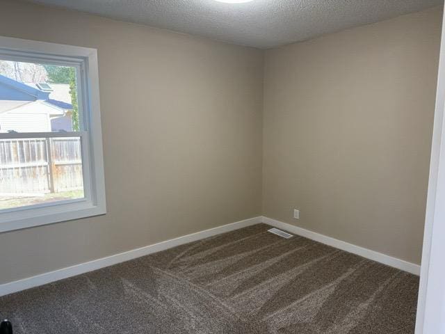 20 Erie St, Aurora, MN 55705 - spare room featuring dark carpet and a textured ceiling