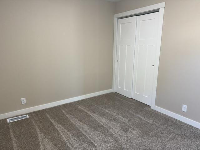 20 Erie St, Aurora, MN 55705 - unfurnished bedroom with dark carpet and a closet