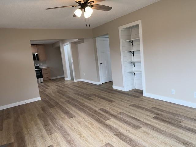 20 Erie St, Aurora, MN 55705 - unfurnished living room featuring ceiling fan and wood finished floors