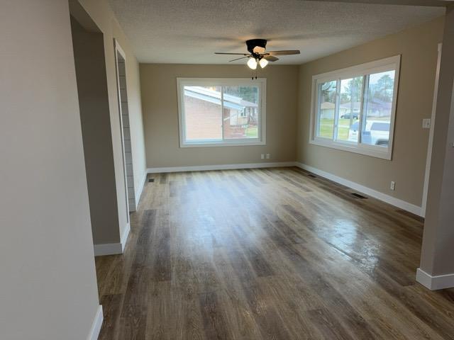 20 Erie St, Aurora, MN 55705 - unfurnished room with wood finished floors, a ceiling fan, and a textured ceiling