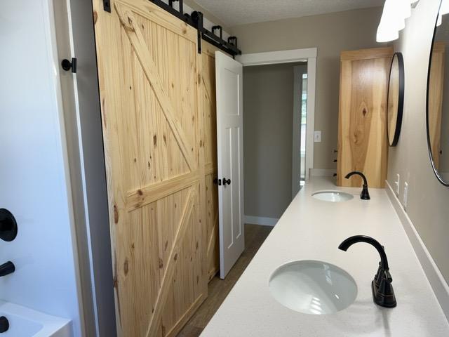 20 Erie St, Aurora, MN 55705 - bathroom with double vanity and shower / bathtub combination