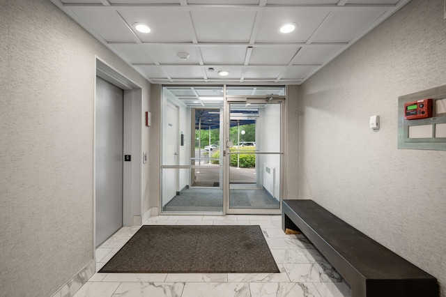 5011 Lake Ave Unit 105, White Bear Lake, MN 55110 - hallway with a textured wall, light marble finish flooring, elevator, and recessed lighting
