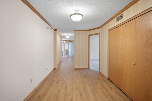 5011 Lake Ave Unit 105, White Bear Lake, MN 55110 - hallway with crown molding, light wood-style flooring, and a textured ceiling