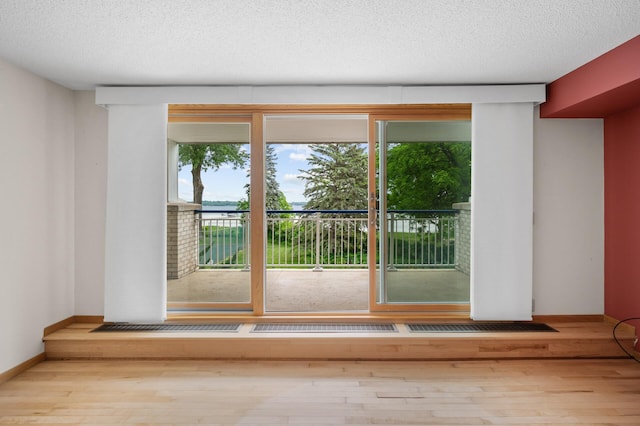 5011 Lake Ave Unit 105, White Bear Lake, MN 55110 - spare room with wood finished floors and a textured ceiling