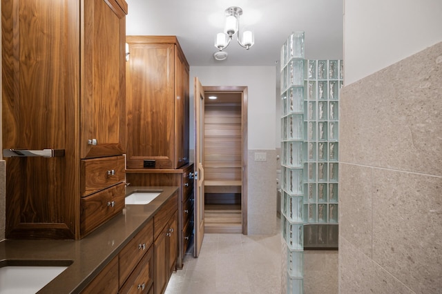 5011 Lake Ave Unit 105, White Bear Lake, MN 55110 - full bathroom featuring double vanity, tile walls, and tile patterned flooring
