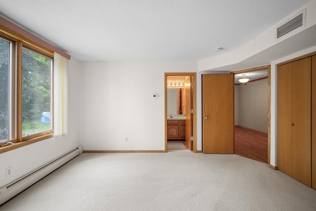 5011 Lake Ave Unit 105, White Bear Lake, MN 55110 - unfurnished bedroom with a baseboard radiator, light carpet, a textured ceiling, connected bathroom, and a closet