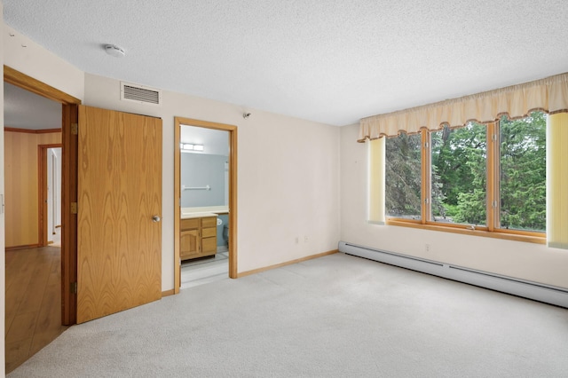 5011 Lake Ave Unit 105, White Bear Lake, MN 55110 - unfurnished bedroom featuring baseboard heating, a textured ceiling, carpet flooring, and connected bathroom
