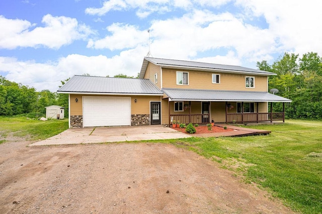 4984 Tower Rd, Moose Lake, MN 55767 - view of front of home with dirt driveway, a porch, a garage, a front yard, and a storage shed