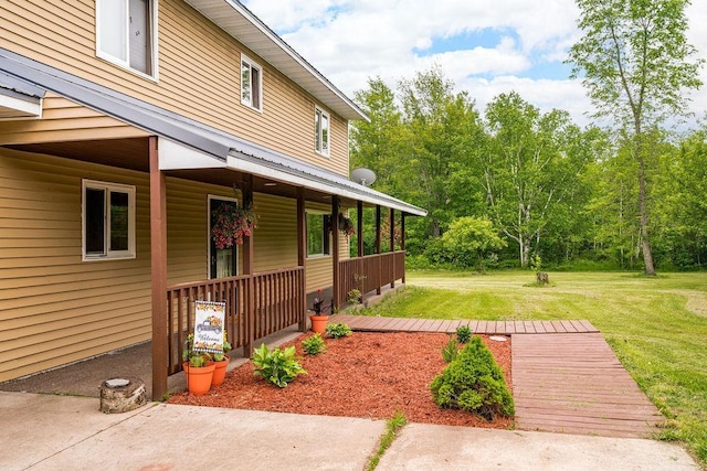 4984 Tower Rd, Moose Lake, MN 55767 - property entrance with a porch and a yard