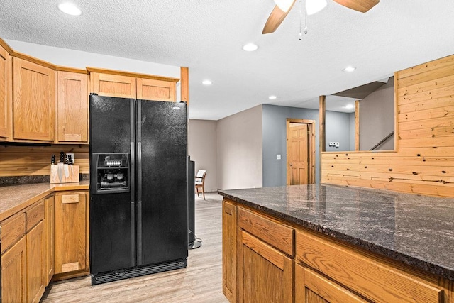 4984 Tower Rd, Moose Lake, MN 55767 - kitchen with black fridge, light wood-style floors, recessed lighting, a ceiling fan, and dark stone countertops