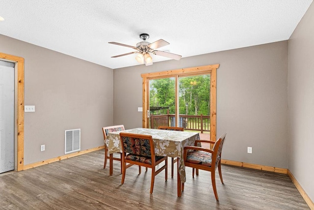 4984 Tower Rd, Moose Lake, MN 55767 - dining space featuring wood finished floors, a ceiling fan, and a textured ceiling