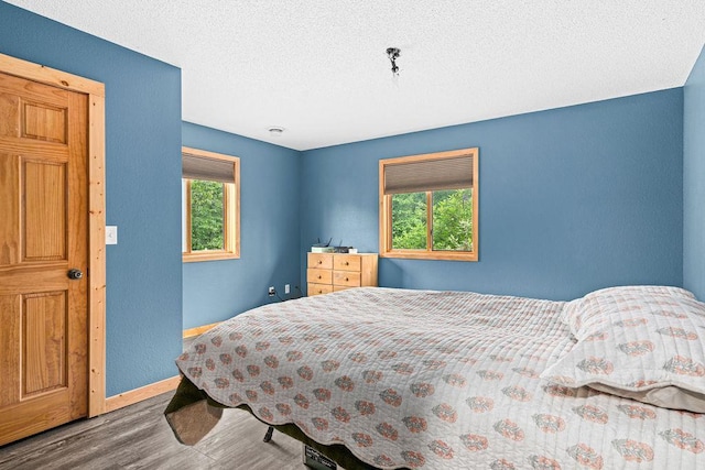 4984 Tower Rd, Moose Lake, MN 55767 - bedroom featuring wood finished floors and a textured ceiling