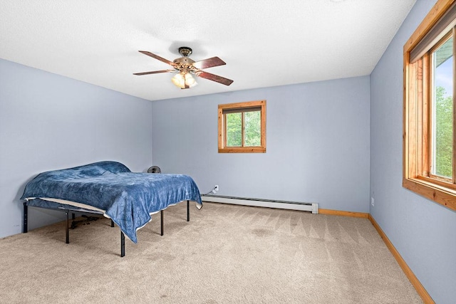 4984 Tower Rd, Moose Lake, MN 55767 - bedroom with a baseboard radiator, carpet floors, and a ceiling fan