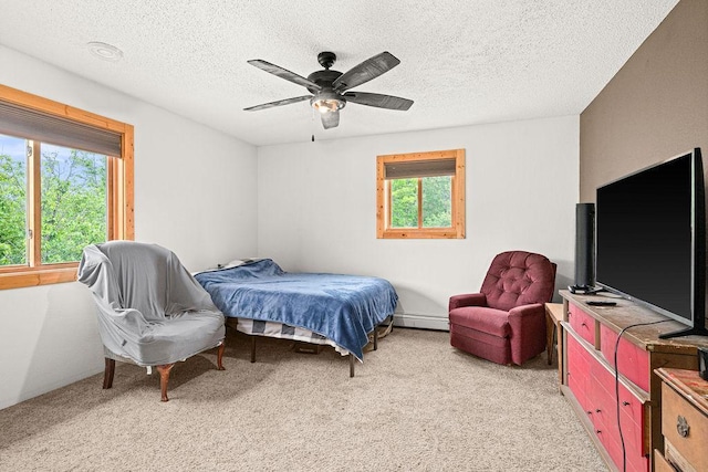 4984 Tower Rd, Moose Lake, MN 55767 - bedroom with a baseboard radiator, light carpet, a textured ceiling, and a ceiling fan