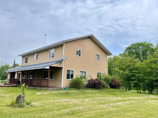 4984 Tower Rd, Moose Lake, MN 55767 - back of house featuring a lawn and covered porch