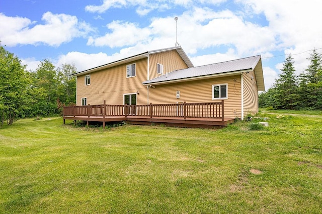 4984 Tower Rd, Moose Lake, MN 55767 - rear view of house featuring a wooden deck, a yard, and a metal roof