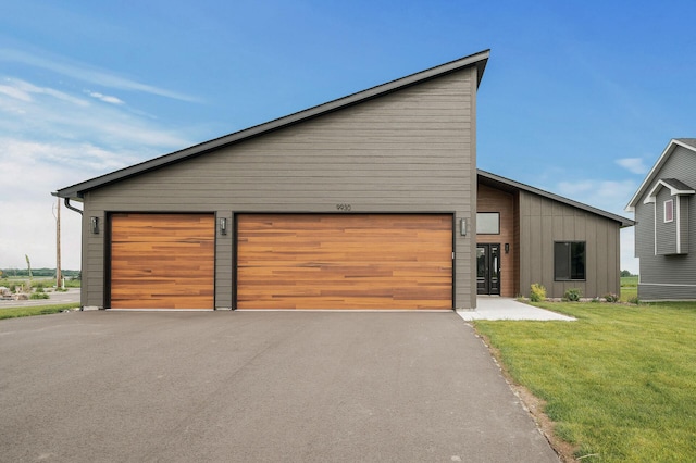 9930 14th Cir NE, Saint Michael, MN 55376 - view of front of house featuring board and batten siding, a front yard, and a garage