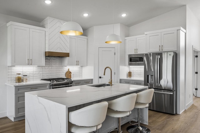 9930 14th Cir NE, Saint Michael, MN 55376 - kitchen featuring stainless steel appliances, decorative backsplash, wood finished floors, light stone countertops, and recessed lighting