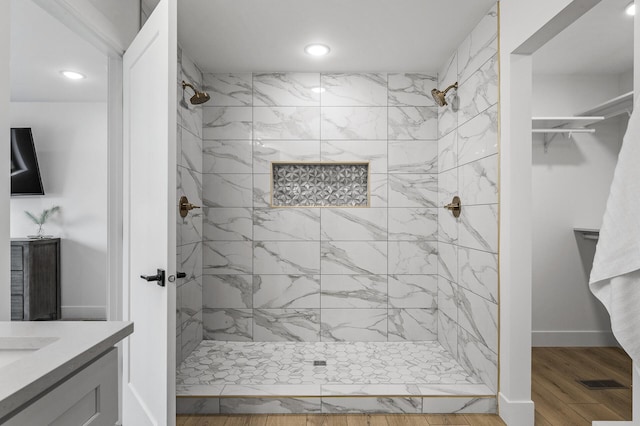 9930 14th Cir NE, Saint Michael, MN 55376 - bathroom with recessed lighting, a tile shower, vanity, wood finished floors, and a walk in closet