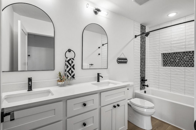 9930 14th Cir NE, Saint Michael, MN 55376 - full bathroom featuring double vanity, shower / bath combination, and wood finished floors