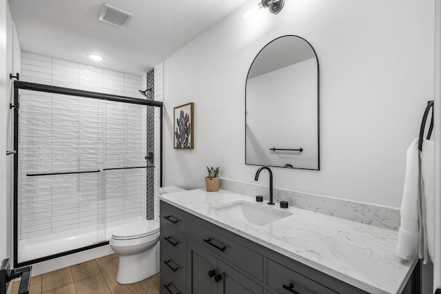 9930 14th Cir NE, Saint Michael, MN 55376 - bathroom featuring vanity, a shower stall, and wood finished floors