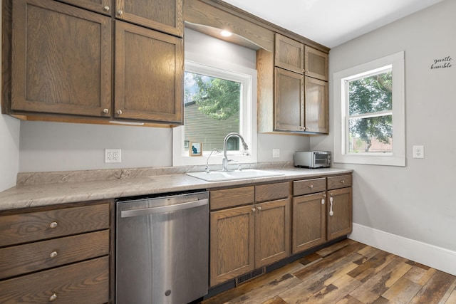 213 2nd St NE, Grand Meadow, MN 55936 - kitchen with stainless steel dishwasher, dark wood-type flooring, plenty of natural light, and light countertops