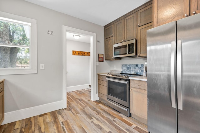 213 2nd St NE, Grand Meadow, MN 55936 - kitchen with appliances with stainless steel finishes, light countertops, and light wood-style floors