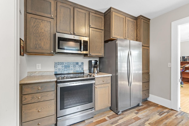 213 2nd St NE, Grand Meadow, MN 55936 - kitchen with appliances with stainless steel finishes, light wood finished floors, and light countertops