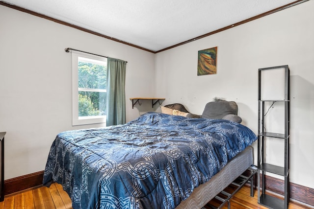 213 2nd St NE, Grand Meadow, MN 55936 - bedroom with hardwood / wood-style flooring, ornamental molding, and a textured ceiling
