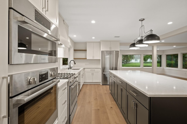 2022 Lake Rd, Minnetonka Beach, MN 55391 - kitchen with stainless steel appliances, open shelves, white cabinetry, a center island, and light wood finished floors