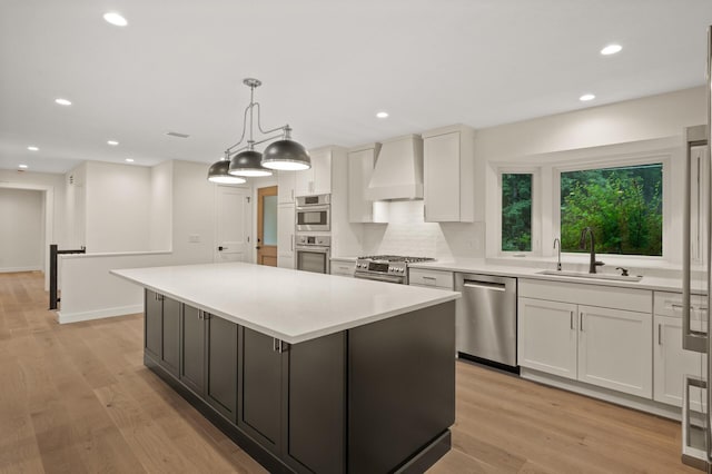 2022 Lake Rd, Minnetonka Beach, MN 55391 - kitchen featuring custom range hood, appliances with stainless steel finishes, a center island, white cabinets, and light countertops