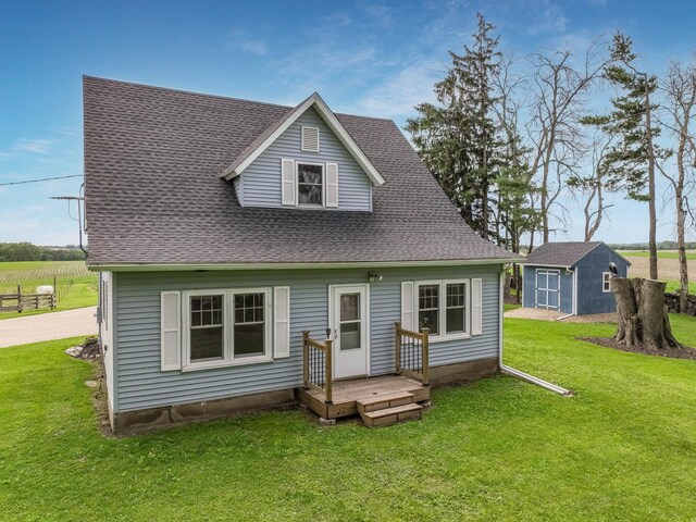 N2498 50th St, Union Twp, WI 54761 - rear view of property featuring roof with shingles, a lawn, and a storage shed