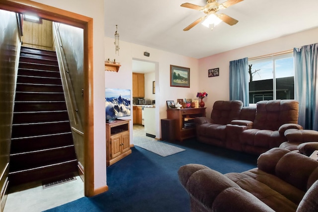 N2498 50th St, Union Twp, WI 54761 - living room with stairs, a ceiling fan, and carpet flooring