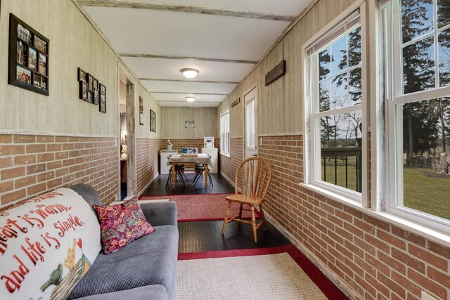 N2498 50th St, Union Twp, WI 54761 - sunroom / solarium with wood finished floors, a wainscoted wall, and brick wall