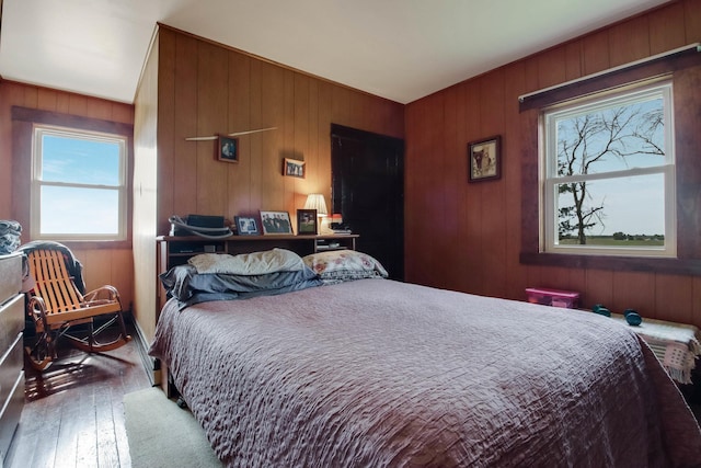 N2498 50th St, Union Twp, WI 54761 - bedroom with multiple windows, wood-type flooring, and wooden walls