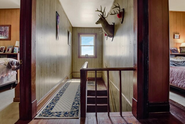 N2498 50th St, Union Twp, WI 54761 - hallway featuring wooden walls, wood finished floors, and an upstairs landing