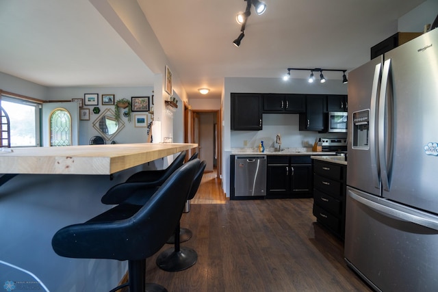 2901 10th Ave N, Fargo, ND 58102 - kitchen featuring appliances with stainless steel finishes, light countertops, dark cabinets, and track lighting