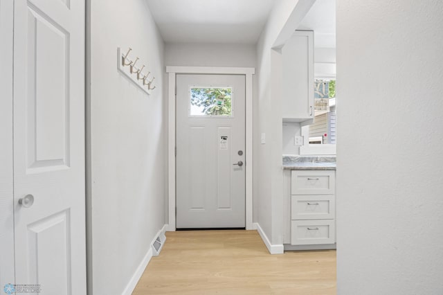 1031 7th St W, West Fargo, ND 58078 - doorway to outside featuring light wood-style floors and baseboards