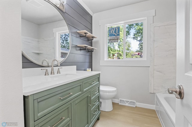 1031 7th St W, West Fargo, ND 58078 - full bathroom featuring vanity, wood finished floors, and bathing tub / shower combination