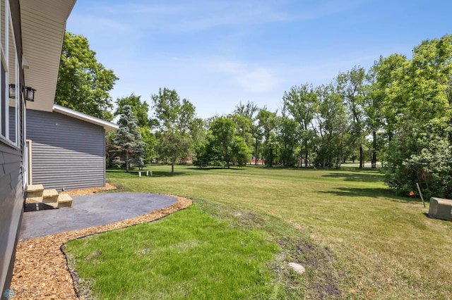 1031 7th St W, West Fargo, ND 58078 - view of grassy yard featuring a patio and view of wooded area