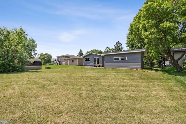 1031 7th St W, West Fargo, ND 58078 - back of house featuring a yard and entry steps