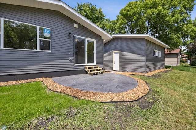 1031 7th St W, West Fargo, ND 58078 - back of house with a lawn, a patio, and entry steps